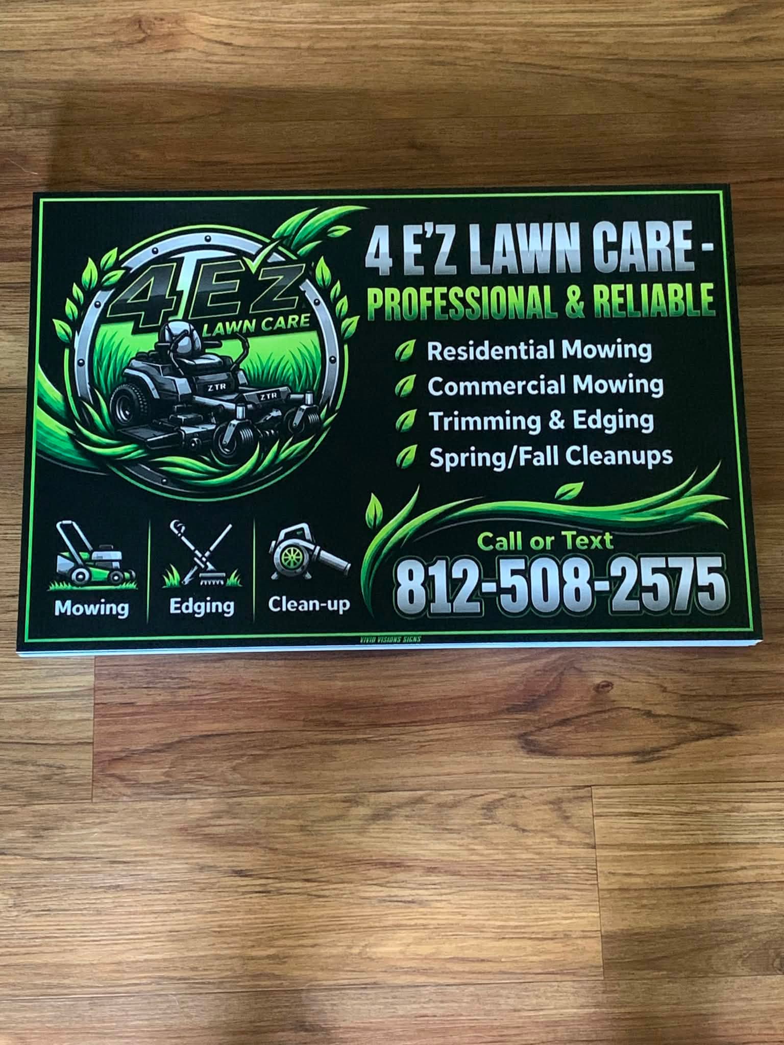 4 E'Z Lawn Care sign listing residential and commercial mowing, trimming and edging, and spring and fall cleanups