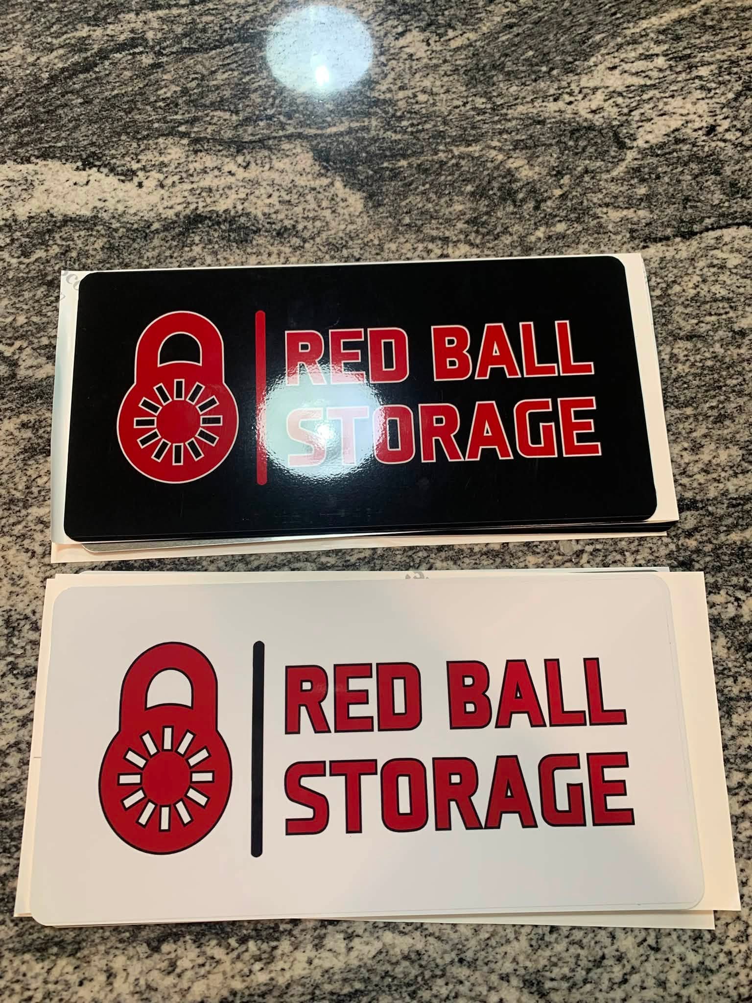 Red Ball Storage decals cut two ways — white on black and black on white
