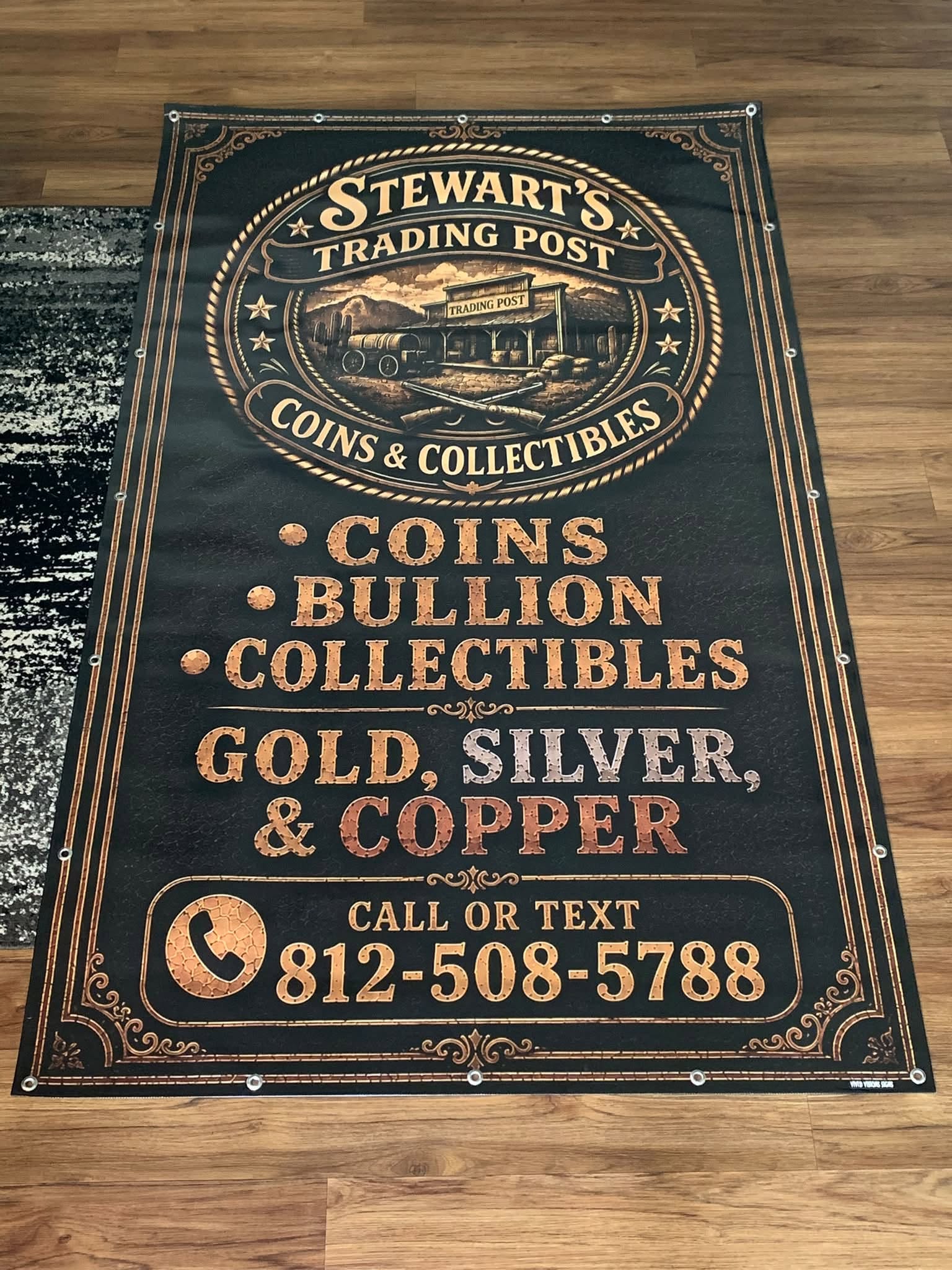 Stewart's Trading Post custom piece in copper and gold on black, listing coins, bullion, and collectibles