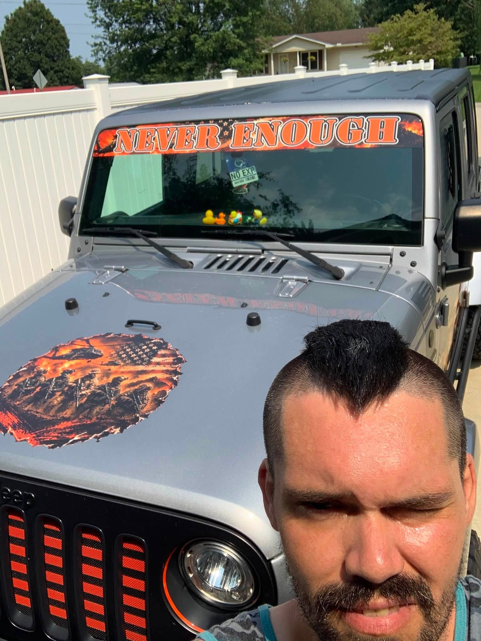 Jeep with a NEVER ENOUGH windshield banner and a full-color hood graphic